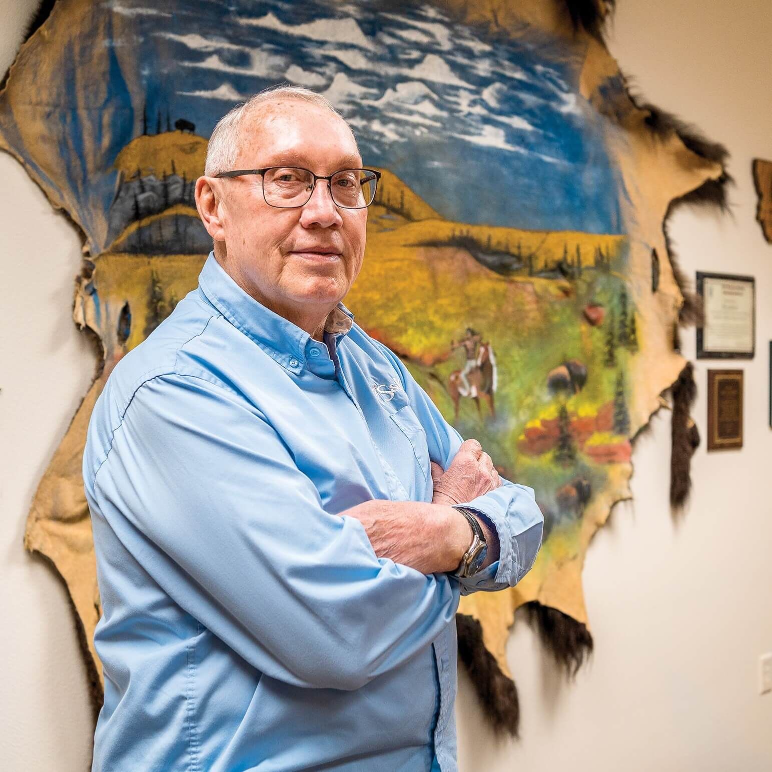 Robert Gauthier, a former director of the Salish &amp; Kootenai Housing Authority, showcases the centerpiece of the many cultural artifacts decorating his conference room. At 73, Gauthier enjoys his retirement by continuing his work with tribal housing. His personal motto is “Building Wealth in Indian Country.”
